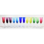 MURANO; a set of twelve champagne flutes each with different coloured bowls, knopped stem and