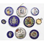 A collection of nine 19th century coins with later enamelled detailing and many with brooch fittings