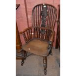 An 18th century Windsor armchair with yew wood back and elm seat, raised on crinoline stretcher, and