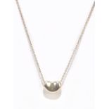 TIFFANY & CO; a silver chain suspending a coffee bean pendant, length of chain approx. 38cm, in