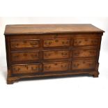 A George III and later oak and stained beech Lancashire mule chest, the hinged lid above six faux