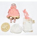 An early 20th century all bisque baby doll, with painted blue eyes and jointed bisque arms and legs,