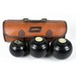 MACCLESFIELD INTEREST; a pair of early 20th century lignum vitae bowling bowls each with applied