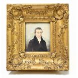 An early 19th century watercolour, three-quarter portrait miniature of a gentleman wearing a black