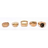 Five 9ct yellow gold signet rings, including an example set with black stone engraved with initial