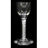 An 18th century wine glass with ogee moulded bowl over opaque air twist stem and circular foot,