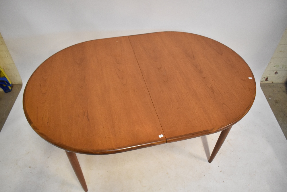 G-PLAN; a mid-century teak extending dining table, raised on turned column supports, with additional - Image 2 of 12