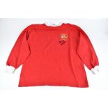 GEORGE BEST; a Manchester United 1963 retro reproduction shirt, signed to the front, size L.