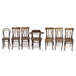 A group of seven bentwood chairs.