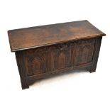 An 18th century oak coffer, with later carved detailing, on stile feet, height 64cm, width 116cm,
