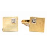 A pair of 9ct gold and diamond cufflinks of square form with engine turned decoration and diamond to