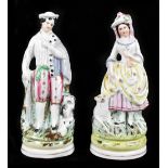 A pair of 19th century Staffordshire figures, he is modelled with dog by his side, and she with a