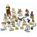 A group of ceramic figures including a Royal Worcester candle snuffer in the form a monk, a