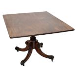 A Regency mahogany tilt-top breakfast table, the rectangular top raised on a carved baluster column,