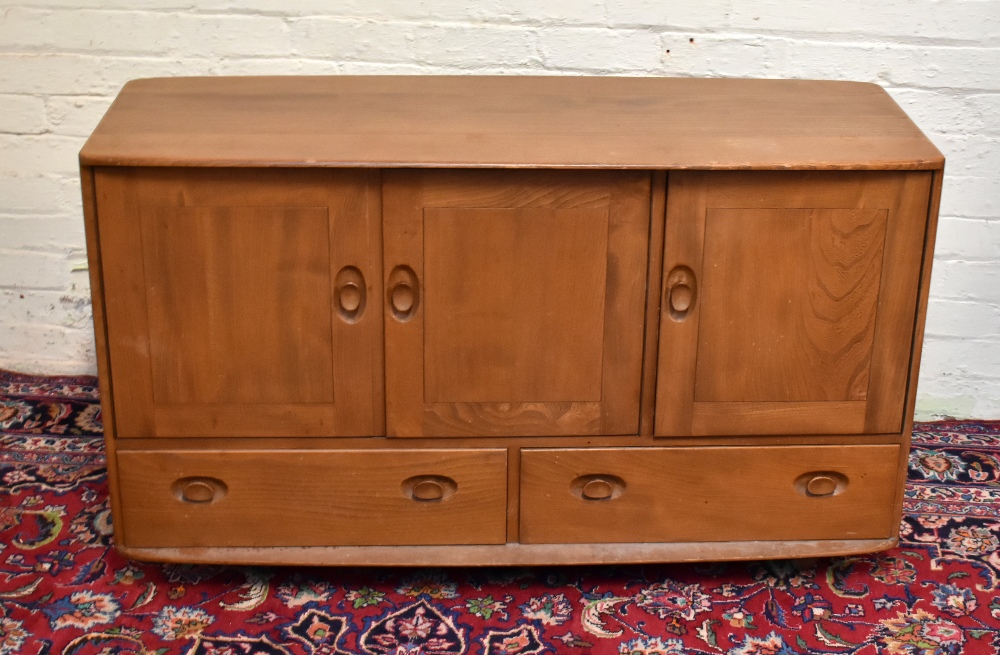 ERCOL; a light elm sideboard with three cupboards above two drawers, width 130cm.Additional
