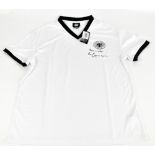 FRANZ BECKENBAUER; a retro Germany shirt, signed to front, size L. Additional InformationCreasing