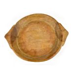 A rustic shallow wooden bowl with shaped handles, width 58cm.