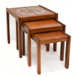 A mid-century nest of teak coffee tables, the larger example set with four ceramic tiles, height