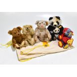 STEIFF; four small size teddy bears and a Steiff panda bear, three with original Steiff bags (5).