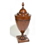 A Edwardian mahogany and chevron strung urn knife box with turned finial above rising lid
