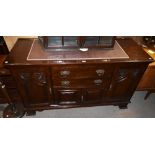 A late 19th century mahogany sideboard with two central drawers with ornate copper plated handles