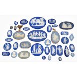 WEDGWOOD; a group of thirty-four predominantly blue jasper dip cameo plaques used in the manufacture