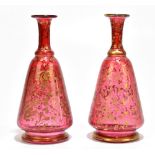 A pair of 19th century Bohemian cranberry glass vases with gilt scrolling decoration, height 17cm (