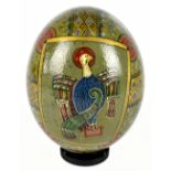 MICHAEL L. NUNN  (South Africa); a painted ostrich egg decorated with mythical animals within a