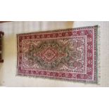 Silk rug in tones of pink and green.- 160 x 93cm