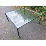 A substantial contemporary glass coffee table on a metal base. Heavy item. 100cm x 100cm glass.