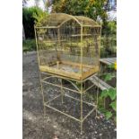 A painted vintage birdcage on a base.
