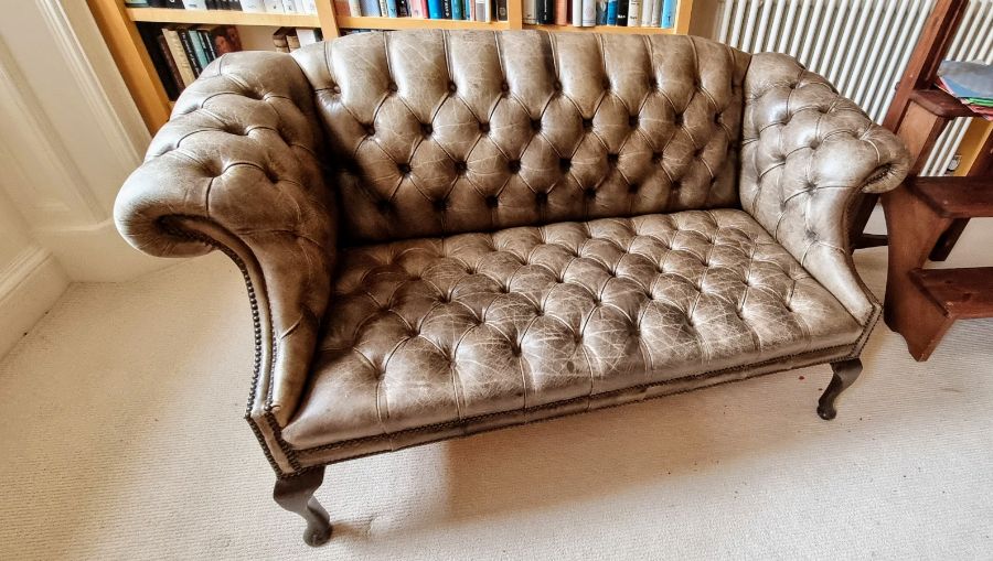 A 2 seater Chesterfield sofa, buttoned leather in olive green/brown.condition Very good. No signs of