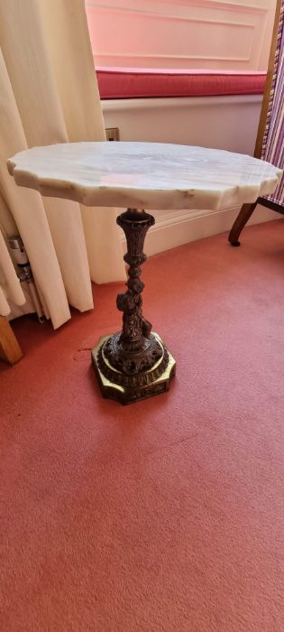 Small wine table with a marble top, a cast leg depicting a classical cherub on a brass base. Maybe a