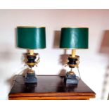 A pair or table lamps on urn bases with country house green shades. Condition. one of the metal