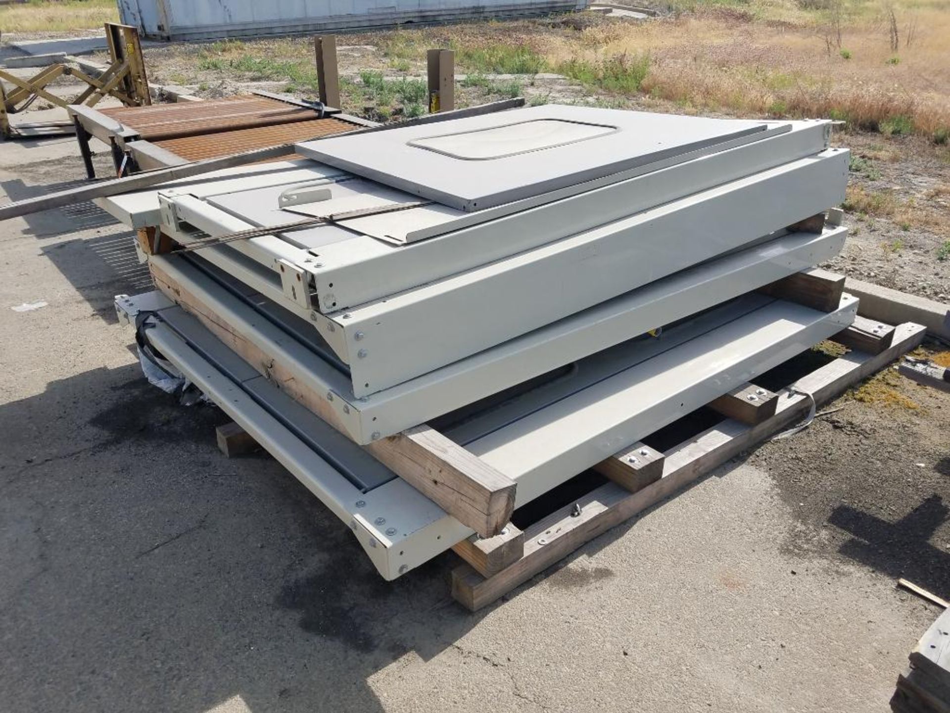 conveyors, forklift slip-sheet attachment, and machine doors