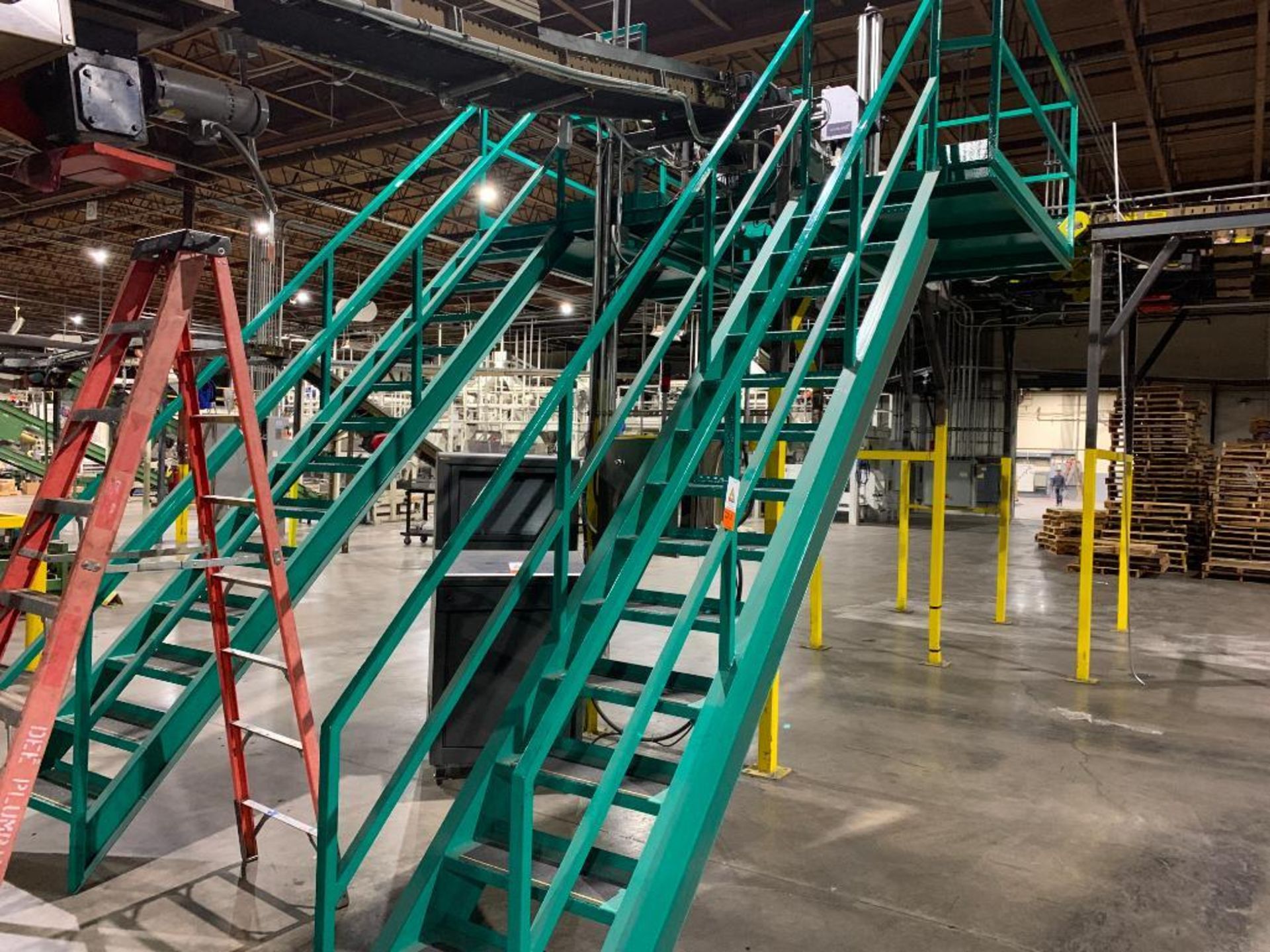 mild steel green mezzanine with two stairs and railing