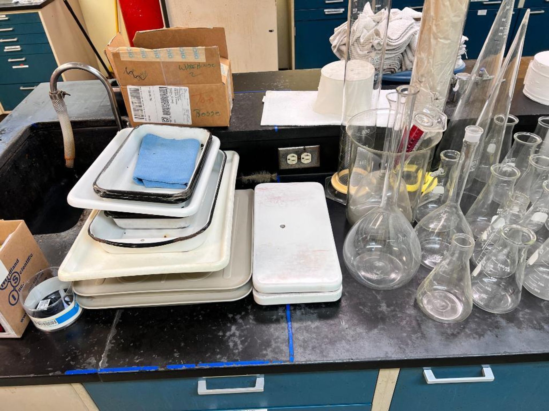 contents of counter including laboratory glass, and analog pull scale