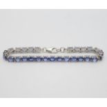 Silver tennis bracelet set with oval tanzanite stones 7.5" 13.5g