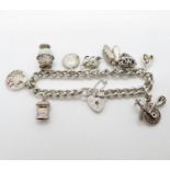 Vintage silver charm bracelet with 9x charms London 1978HM 52g