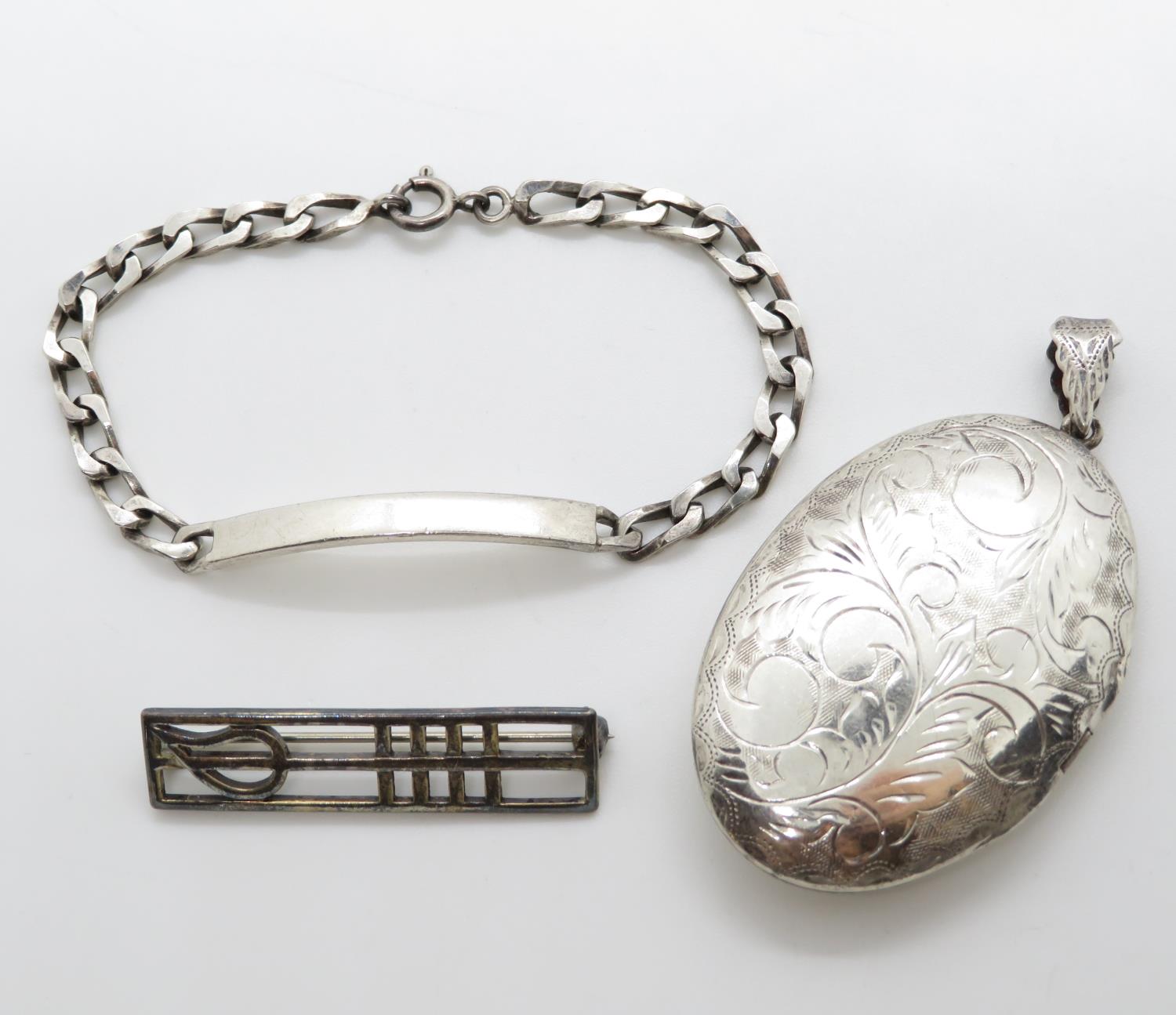 2" silver locket along with silver Mackintosh brooch and silver ID bracelet 34g