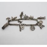 Silver charm bracelet with 11x charms Birmingham 1980 7.25" 28.5g