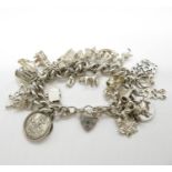 Silver charm bracelet with 29x charms London 1978 114g