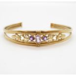 Early 9ct gold bangle with purple stones 6.3g