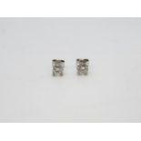 Pair of diamond solitaire earrings with 18ct white gold mounts
