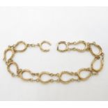 9ct gold HM bracelet of lucky horseshoes 9.5g