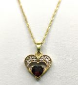 Heart pendant with garnet and two small diamonds, set in 585/14K yellow gold, on chain 585/14K yell