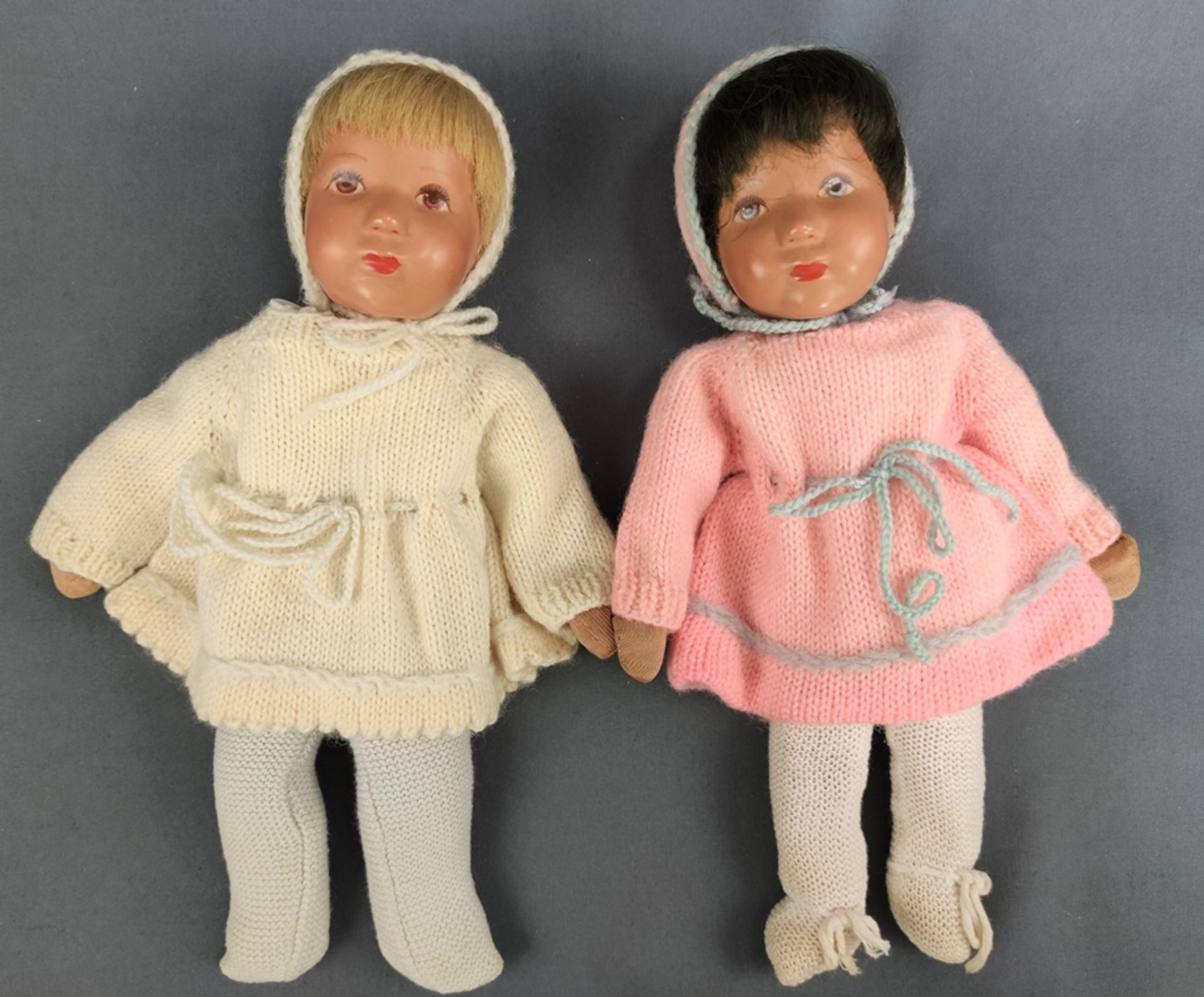 Two small dolls, cloth body with wire, filled, plastic heads finely painted, one real hair wig in b