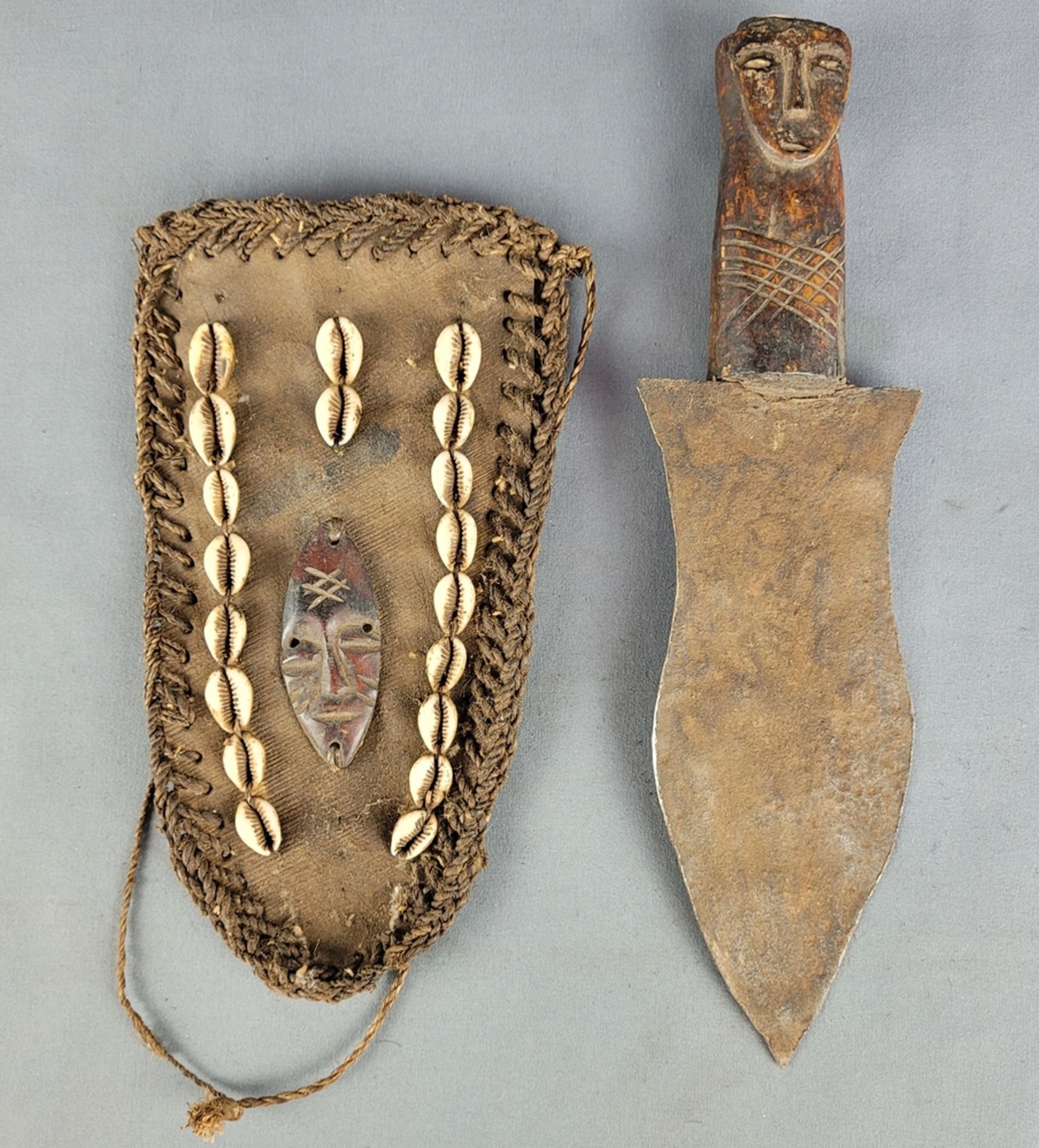 Copper dagger of the Yoruba, with wooden handle carved in the shape of a head, leather sheath