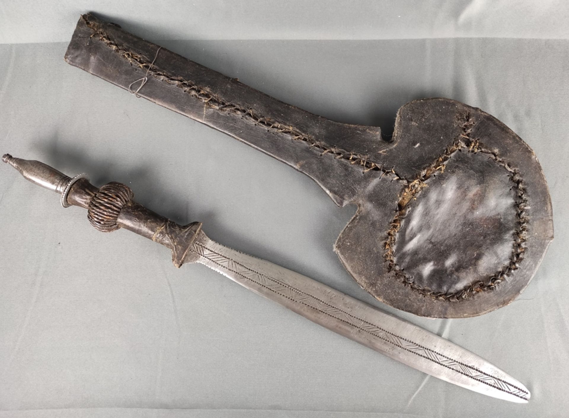 Short sword of the Yaka, "Mbeeli ya Phoko", southeastern Congo, distinctive by disc-shaped scabbard,