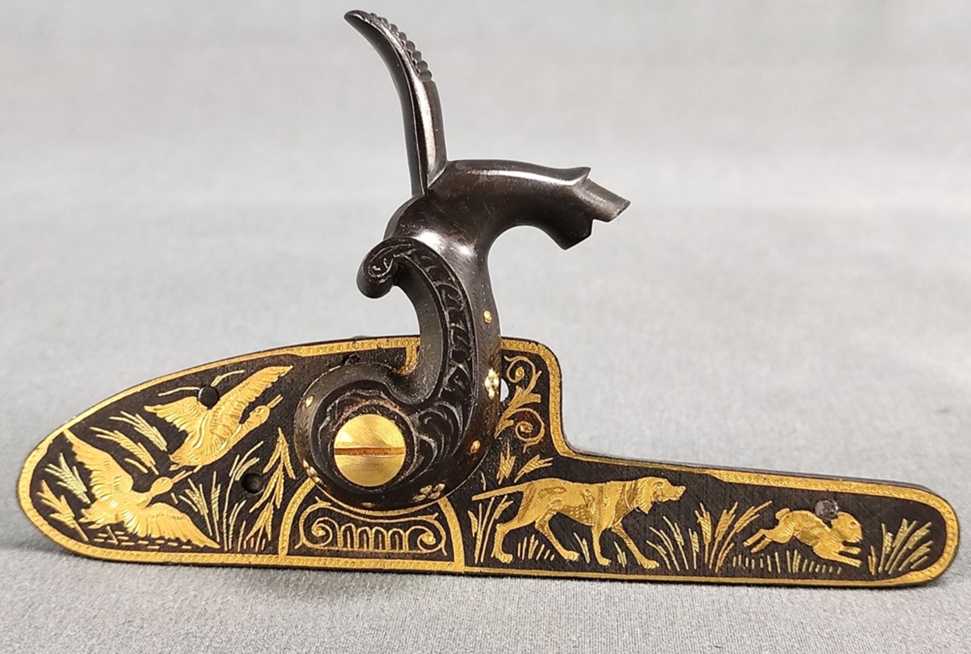 Percussion lock, mounted cock with brass screw, base chased and gilded with hunting scene,